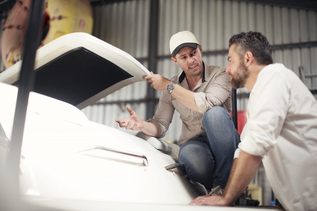 two-men-checking-boat-bodywork-in-repair-workshop-2022-03-04-01-55-02-utc-1024x683